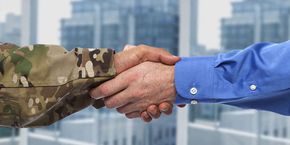 Employer shakes hands with veteran, representing top jobs for military veterans