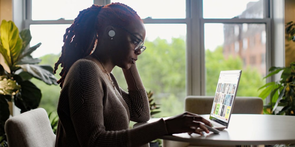 In the context of a blog on screening remote workers, an image features a woman working remotely