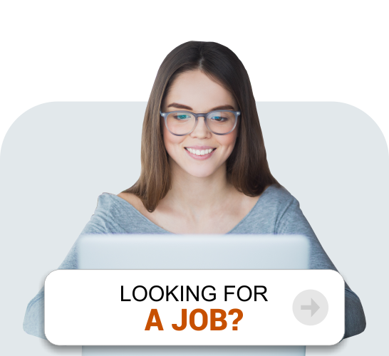 A professional woman wearing spectacles and smiling while looking for a job on the laptop