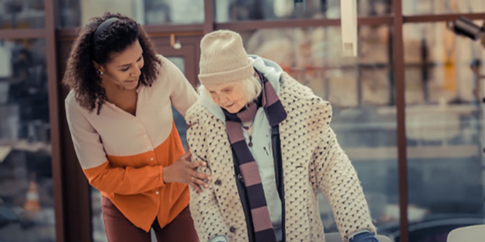 A young woman assisting an elderly lady exemplifies small act of empathy